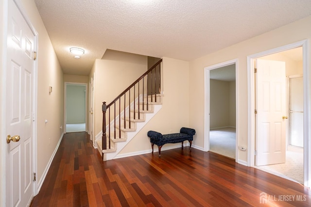 85 W Shrewsbury Pl, Princeton, NJ 08540 - stairway with wood finished floors, baseboards, and a textured ceiling