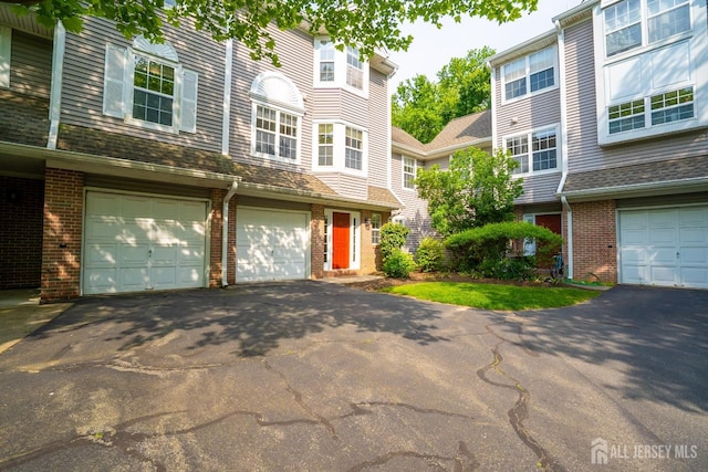 85 W Shrewsbury Pl, Princeton, NJ 08540 - view of property with asphalt driveway, brick siding, and a garage