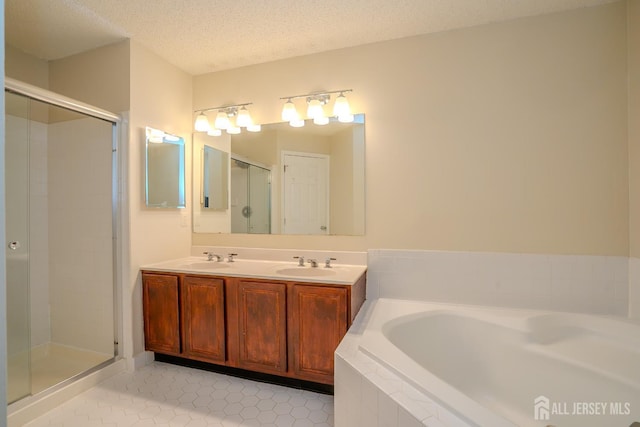 85 W Shrewsbury Pl, Princeton, NJ 08540 - bathroom featuring a bath, tile patterned floors, a shower stall, double vanity, and a textured ceiling