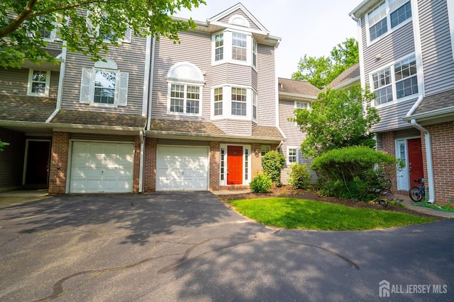 85 W Shrewsbury Pl, Princeton, NJ 08540 - multi unit property with asphalt driveway, a garage, and brick siding