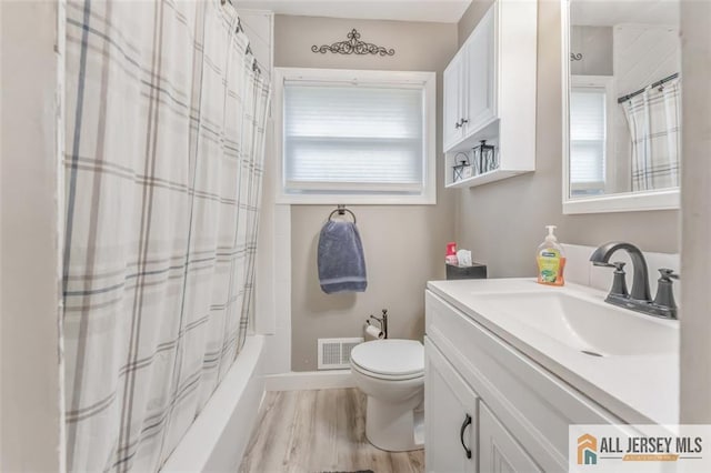 111 E 5th Ave, Port Reading, NJ 07064 - full bathroom with vanity, toilet, wood finished floors, and shower / tub combo