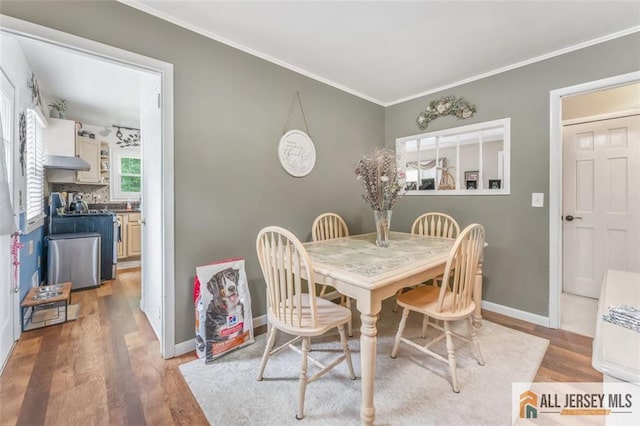 111 E 5th Ave, Port Reading, NJ 07064 - dining space featuring light wood finished floors, ornamental molding, and baseboards