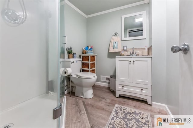 111 E 5th Ave, Port Reading, NJ 07064 - bathroom featuring a shower with door, ornamental molding, vanity, toilet, and wood finished floors