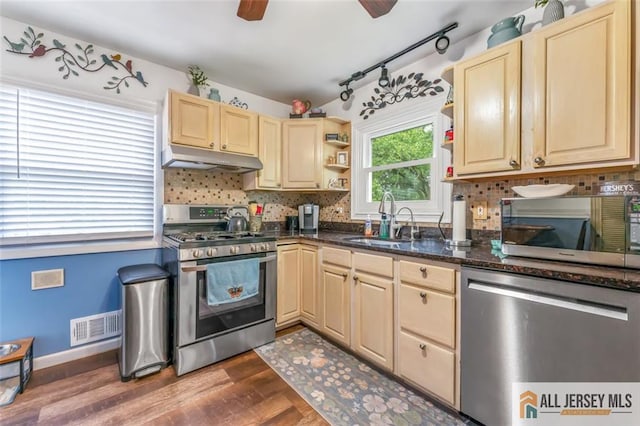 111 E 5th Ave, Port Reading, NJ 07064 - kitchen with stainless steel appliances, a sink, under cabinet range hood, open shelves, and backsplash