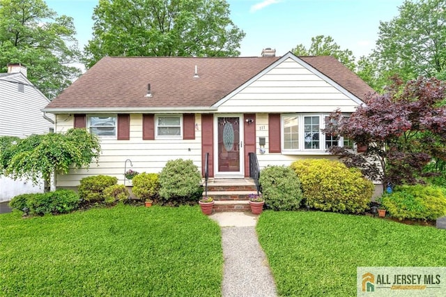 111 E 5th Ave, Port Reading, NJ 07064 - view of front of house featuring a shingled roof, a front yard, and a chimney