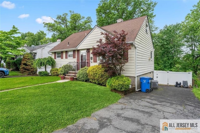 111 E 5th Ave, Port Reading, NJ 07064 - view of front of property with driveway, roof with shingles, a chimney, and a gate