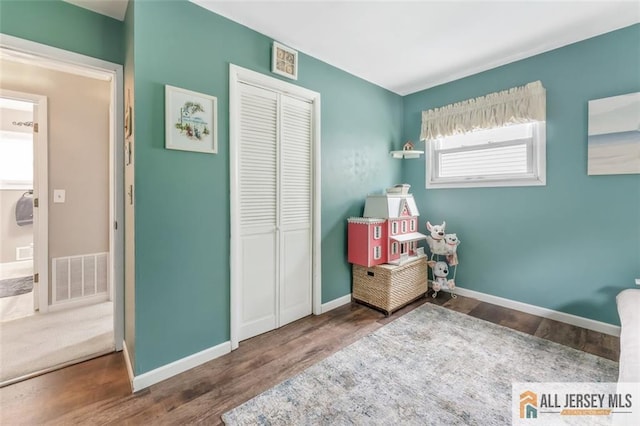 111 E 5th Ave, Port Reading, NJ 07064 - bedroom featuring wood finished floors, a closet, and baseboards