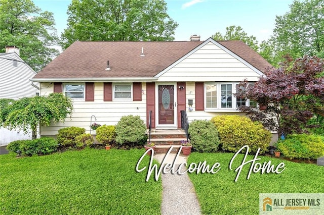 111 E 5th Ave, Port Reading, NJ 07064 - view of front of home featuring a front yard, a shingled roof, and a chimney