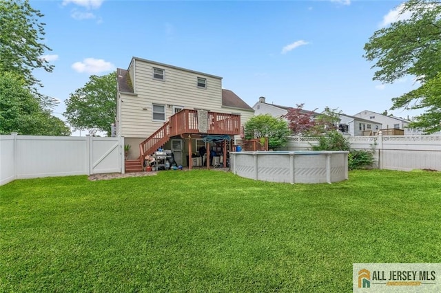 111 E 5th Ave, Port Reading, NJ 07064 - back of house featuring a wooden deck, stairway, and a gate