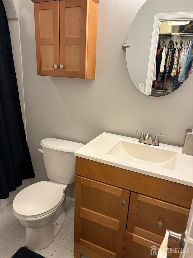 bathroom with tile patterned floors, vanity, and toilet