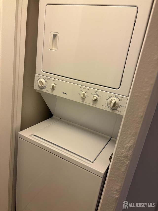 washroom with stacked washer / dryer