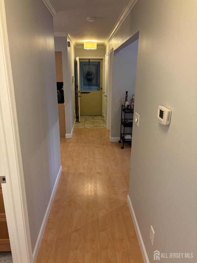hall featuring ornamental molding and baseboards