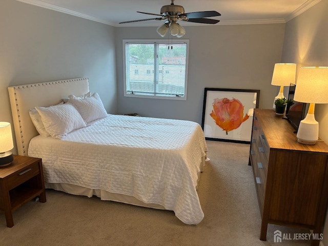 carpeted bedroom featuring ornamental molding and ceiling fan