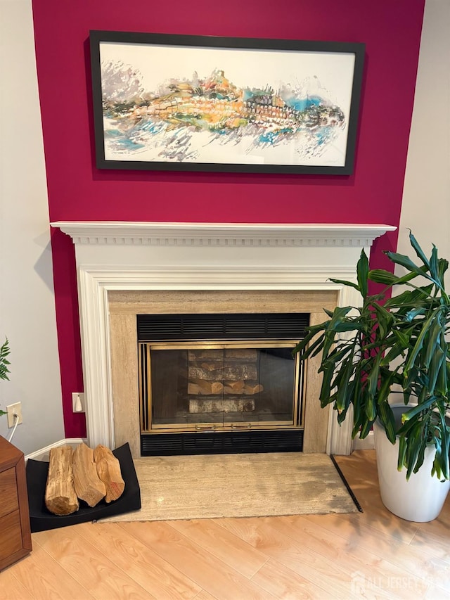 detailed view of a fireplace and wood finished floors