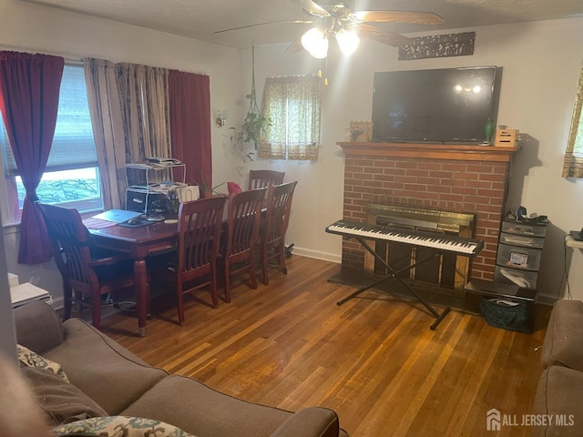 131 Berkeley Ter, Plainfield, NJ 07062 - dining room with wood finished floors, a ceiling fan, and a fireplace