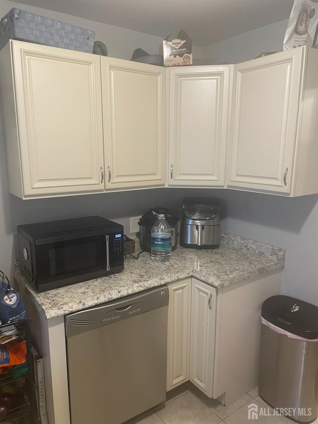 131 Berkeley Ter, Plainfield, NJ 07062 - kitchen featuring stainless steel dishwasher, black microwave, light tile patterned floors, and white cabinetry