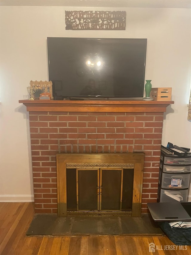 131 Berkeley Ter, Plainfield, NJ 07062 - detailed view of a brick fireplace and wood finished floors