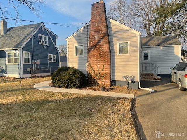 131 Berkeley Ter, Plainfield, NJ 07062 - view of side of property with a chimney and a lawn