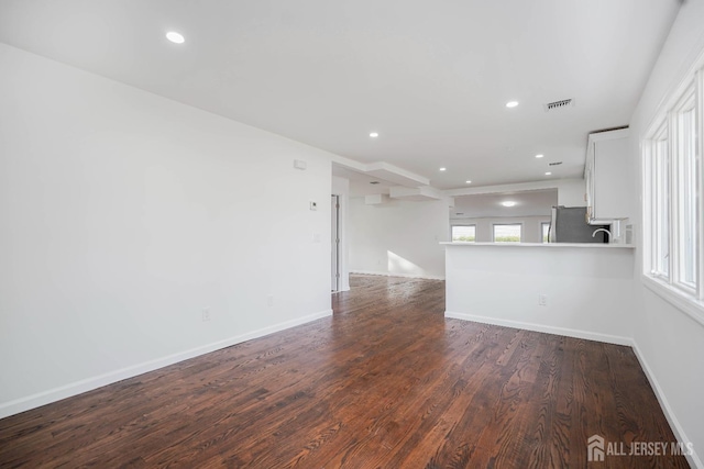 2 Buttonwood Dr, Parlin, NJ 08859 - unfurnished living room with dark wood-style flooring, recessed lighting, and baseboards