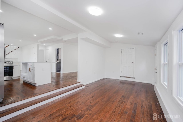 2 Buttonwood Dr, Parlin, NJ 08859 - unfurnished living room featuring dark wood-style flooring, baseboards, and lofted ceiling