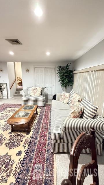 living area featuring visible vents and recessed lighting