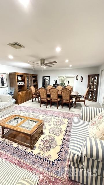 carpeted living room featuring recessed lighting, visible vents, and ceiling fan