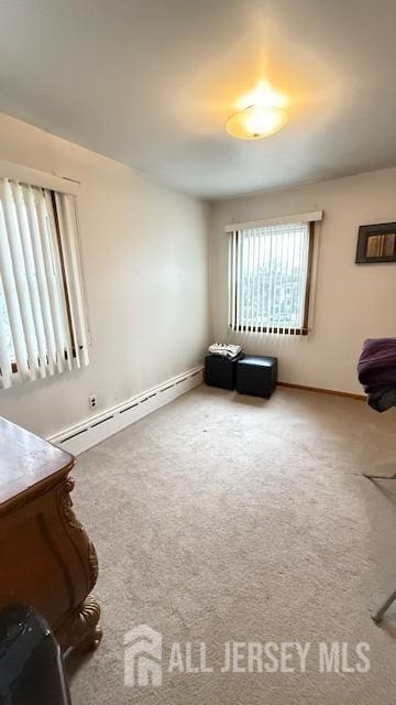 unfurnished room with carpet and a baseboard radiator