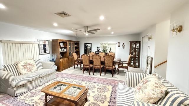 living area featuring visible vents, a ceiling fan, and recessed lighting