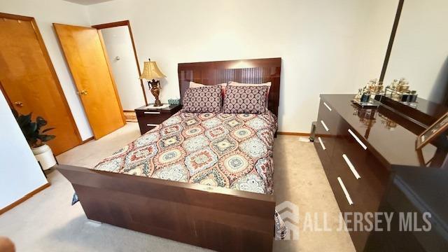 carpeted bedroom with baseboards