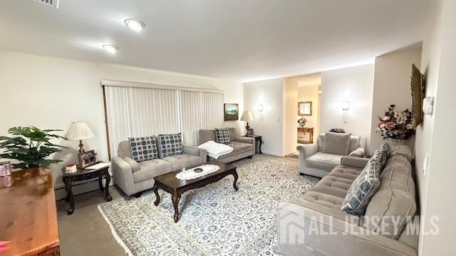 living room with carpet and visible vents