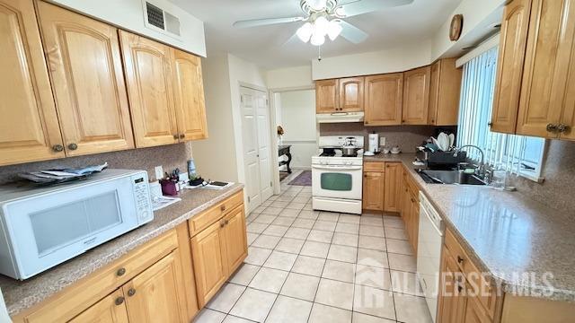 kitchen with ceiling fan, under cabinet range hood, white appliances, a sink, and visible vents