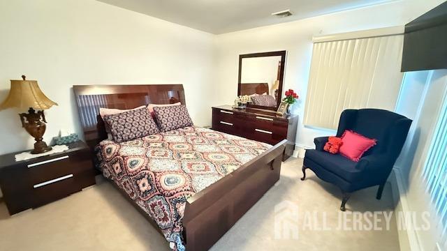 bedroom featuring carpet floors and visible vents