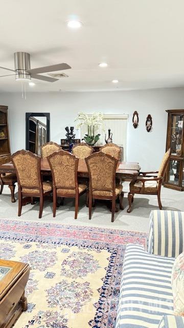 dining space featuring light carpet, ceiling fan, and recessed lighting