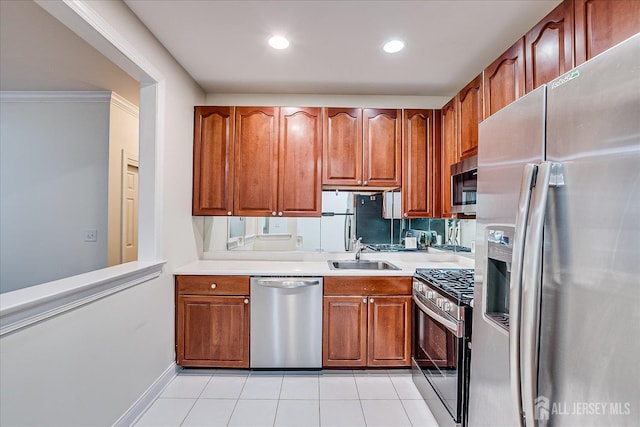 78 Central Ave Unit 49, Metuchen, NJ 08840 - kitchen with appliances with stainless steel finishes, a sink, brown cabinets, light countertops, and light tile patterned floors