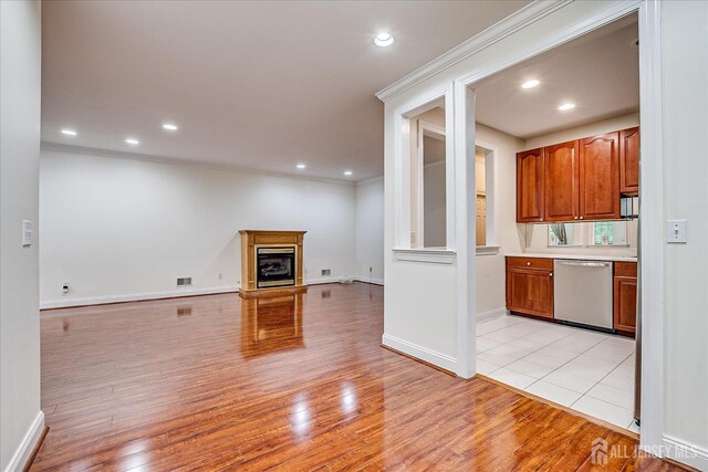 78 Central Ave Unit 49, Metuchen, NJ 08840 - unfurnished living room with light wood-type flooring, recessed lighting, ornamental molding, and a fireplace