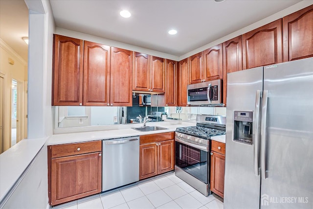 78 Central Ave Unit 49, Metuchen, NJ 08840 - kitchen with appliances with stainless steel finishes, a sink, light countertops, brown cabinetry, and light tile patterned floors