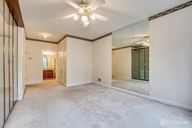 78 Central Ave Unit 49, Metuchen, NJ 08840 - unfurnished bedroom with light colored carpet, a closet, baseboards, a ceiling fan, and ensuite bath