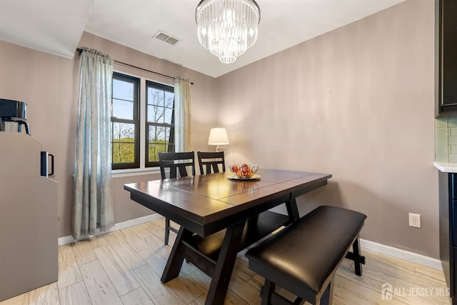 144-C Overlook Ct Unit C, Woodbridge Proper, NJ 07095 - dining room featuring a chandelier, baseboards, and light wood-type flooring