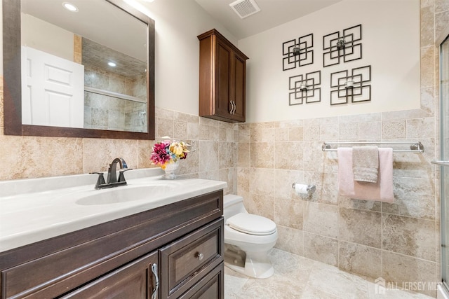 144-C Overlook Ct Unit C, Woodbridge Proper, NJ 07095 - bathroom with tile walls, a stall shower, toilet, vanity, and tile patterned floors
