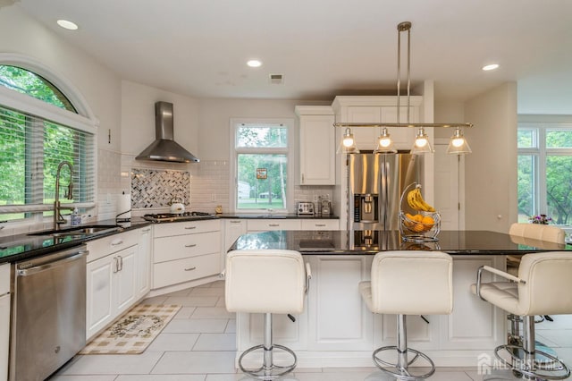 5 Ramapo Ct, Colts Neck, NJ 07722 - kitchen featuring appliances with stainless steel finishes, wall chimney exhaust hood, tasteful backsplash, white cabinets, and recessed lighting