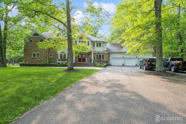 5 Ramapo Ct, Colts Neck, NJ 07722 - view of front facade featuring a front yard, driveway, and a garage