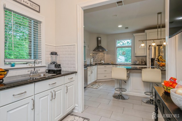 5 Ramapo Ct, Colts Neck, NJ 07722 - kitchen featuring wall chimney exhaust hood, decorative backsplash, light tile patterned floors, white cabinetry, and gas cooktop