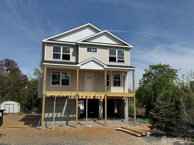 view of front of property with a storage shed and an outdoor structure