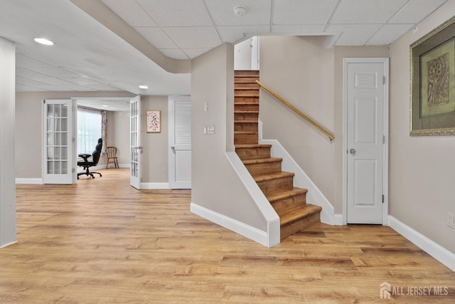 16 Exeter Pass, Colts Neck, NJ 07722 - stairway with a paneled ceiling, baseboards, wood finished floors, french doors, and recessed lighting