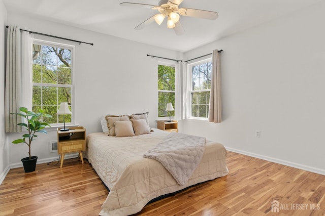 16 Exeter Pass, Colts Neck, NJ 07722 - bedroom featuring multiple windows, light wood-style flooring, and a ceiling fan