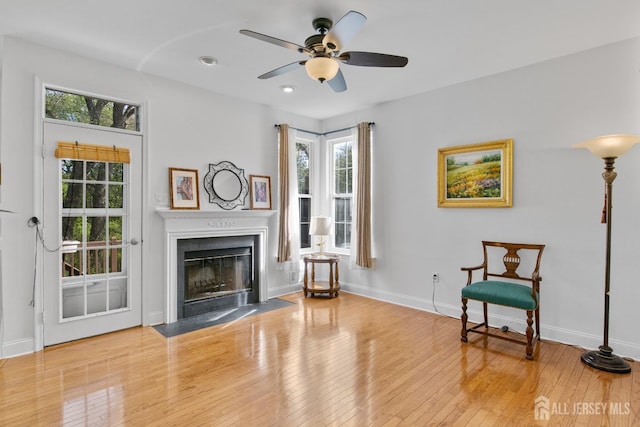 16 Exeter Pass, Colts Neck, NJ 07722 - living area with wood-type flooring, a fireplace with flush hearth, plenty of natural light, and recessed lighting