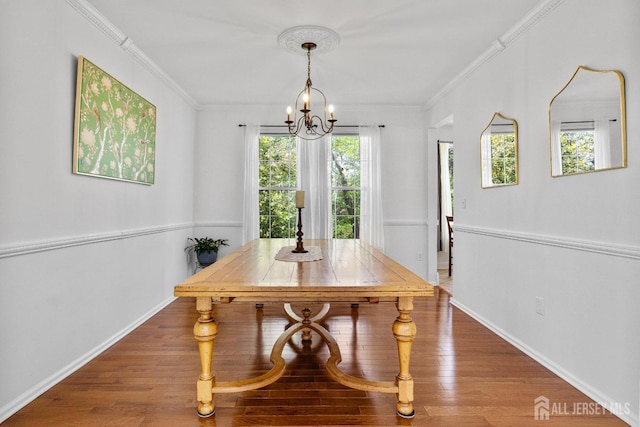 16 Exeter Pass, Colts Neck, NJ 07722 - dining area featuring a chandelier, healthy amount of natural light, baseboards, wood finished floors, and crown molding