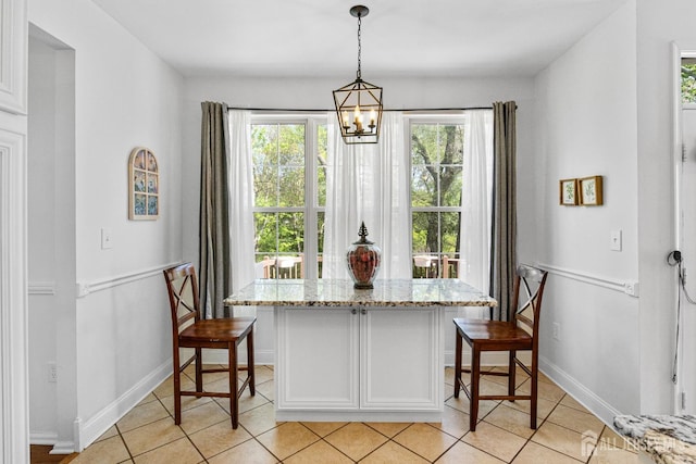 16 Exeter Pass, Colts Neck, NJ 07722 - dining area with light tile patterned floors, a chandelier, and baseboards