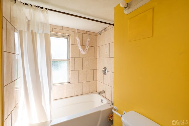 bathroom featuring shower / bathtub combination with curtain and toilet