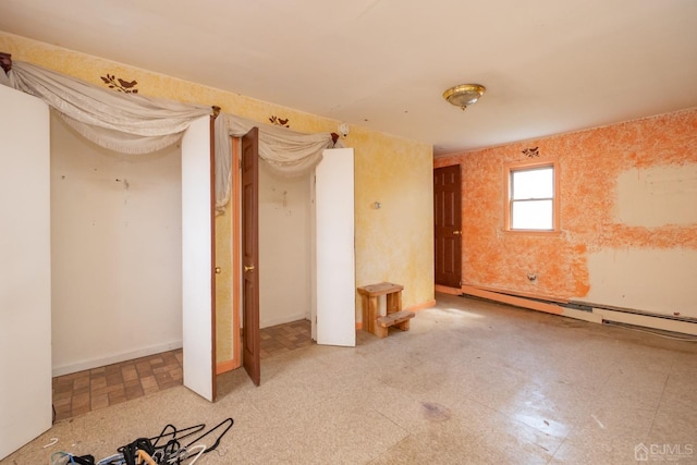 unfurnished bedroom featuring a baseboard heating unit